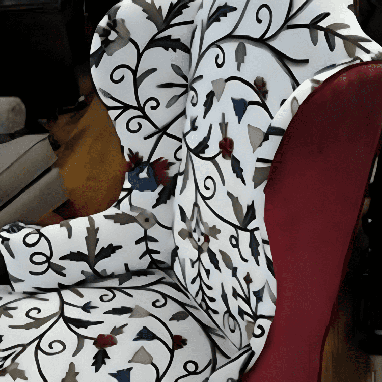 Stylish chair with floral patterned upholstery and red velvet sides.