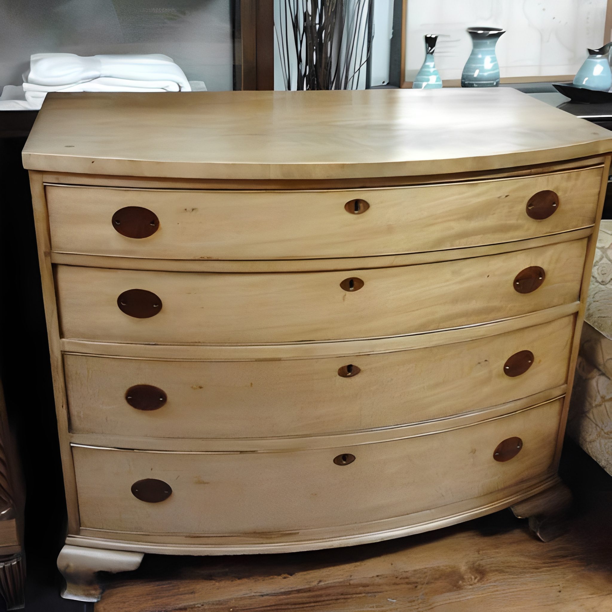 Wooden dresser with four drawers and handles.